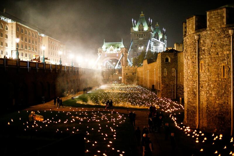 The moat of the Tower of London is seen filled with thousands of lit torches as part of the installation 'Beyond the Deepening Shadow', in London. Reuters