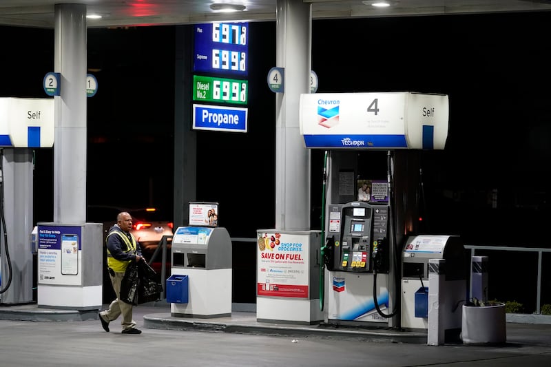 An attendant walks past a pump at a station selling petrol at almost $7 a gallon in Los Angeles, California. AP