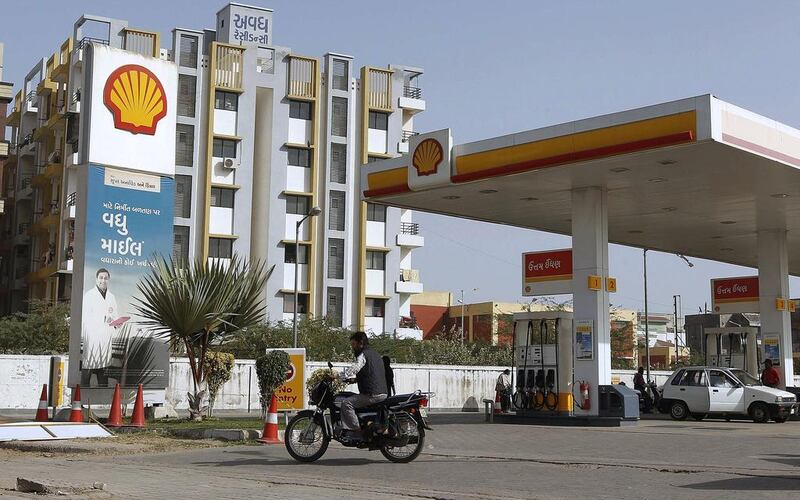 A man rides his motorcycle past a Shell fuel station on the outskirts of the western Indian city of Ahmedabad. Amit Dave / Reuters