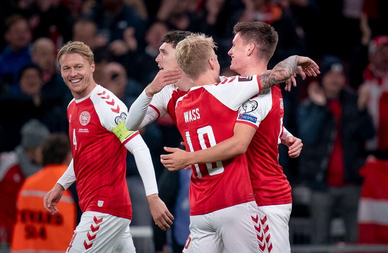 Denmark's Joakim Maehle (R) celebrates with teammates after scoring the 1-0 goal during the FIFA World Cup 2022 qualification soccer match between Denmark and Austria at Parken Stadium in Copenhagen, Denmark, 12 October 2021.   EPA / Liselotte Sabroe  DENMARK OUT