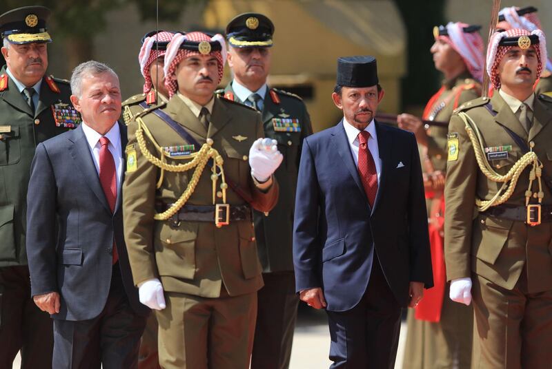 The Sultan of Brunei Hassanal Bolkiah (R) and Jordan's King Abdullah II (L) review the honour guard at the Royal Palace in Amman, Jordan. The Sultan of Brunei is on an official visit in Jordan. AFP