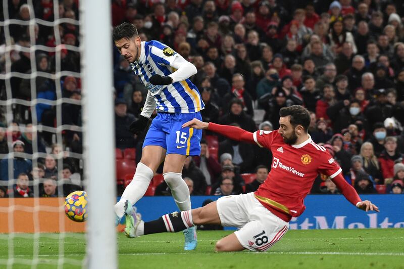 Brighton's Jakub Moder shoots at goal under pressure from Manchester United midfielder Bruno Fernandes. AP