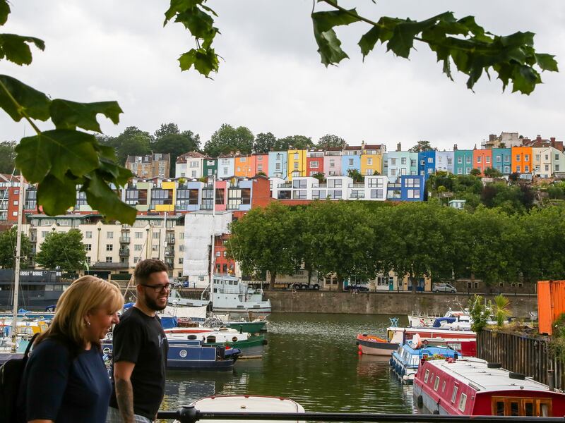 A couple walks past houses overlooking Bristol harbour. Britain’s property market experienced a mini-boom during the Covid-19 pandemic. Getty Images