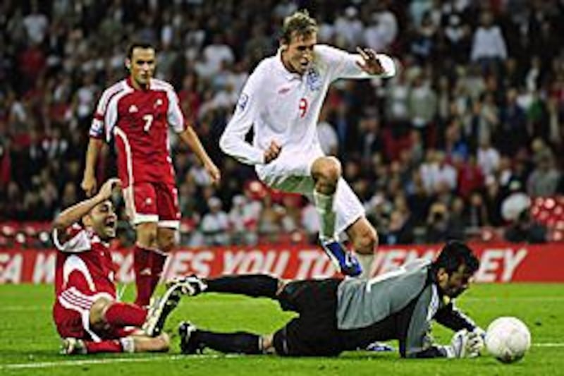 England's Peter Crouch, centre, scores past the Andorra goalkeeper Koldo Alvarez.