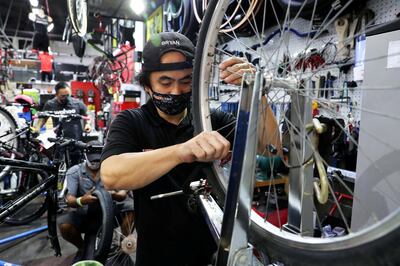 DUBAI, UNITED ARAB EMIRATES , May 26 – 2020 :- Bryan Manila, bicycle mechanic from Philippines working at the Revolution Cycles Dubai at Dubai Motor City in Dubai. He is wearing protective face mask as a preventive measure against the spread of coronavirus at the store. (Pawan Singh / The National) For News/Online/Instagram. Story by Kelly