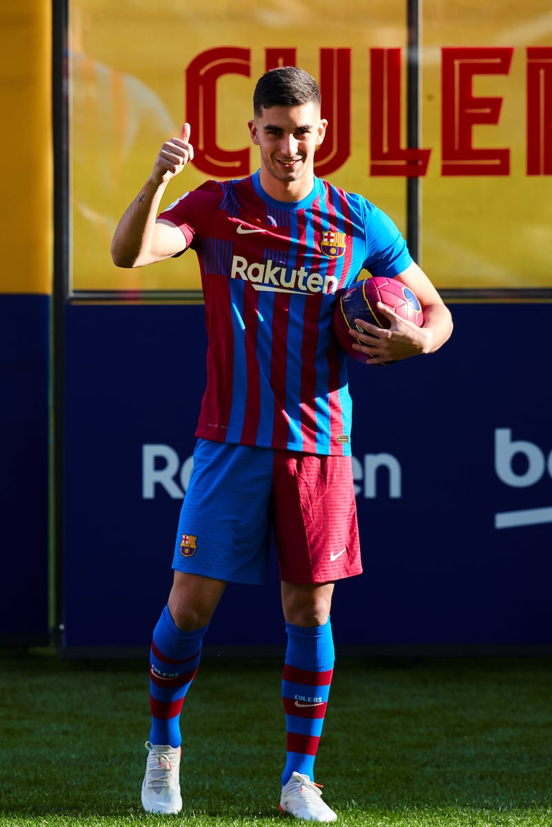 Spanish striker Ferran Torres poses during his presentation as new Barcelona player at Camp Nou. EPA