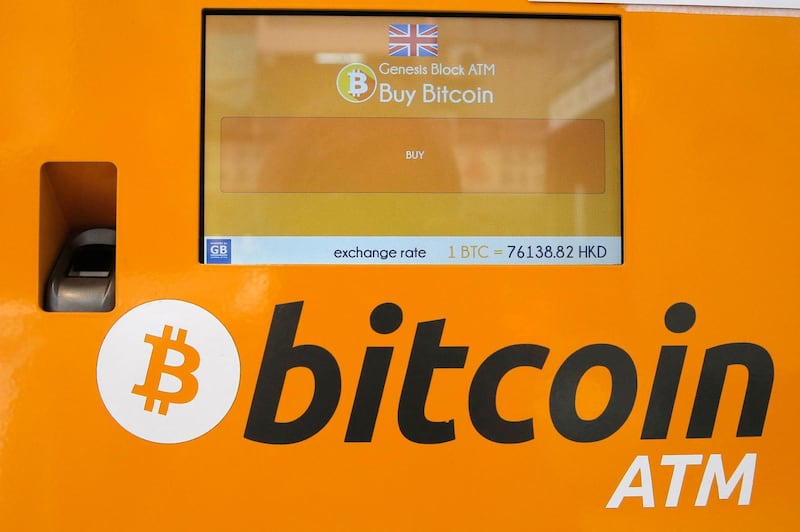 FILE- This May 11, 2018, file photo shows a Bitcoin ATM in Hong Kong. The price of bitcoin has fallen to a four-month low of $6,370, days after South Korean virtual currency exchange Coinrail said hackers had stolen over $37 million, or almost a third of the virtual currency it had stored. (AP Photo/Kin Cheung, File)
