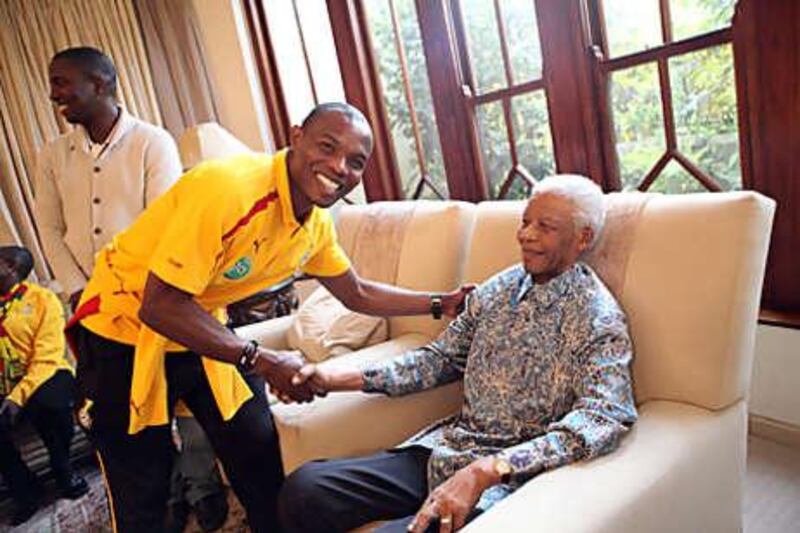 Richard Kingston, the Ghana goalkeeper, left, greets Nelson Mandela yesterday, a day after Ghana had exited the World Cup in a penalty shoot-out.