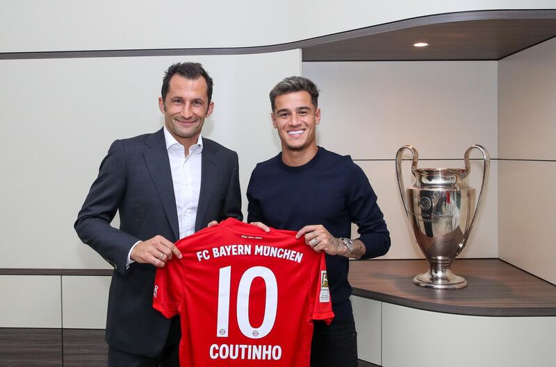 Brazilian midfielder Philippe Coutinho, right, poses with a No 10 Bayern Munich shirt alongside sporting director Hasan Salihamidzic. AFP