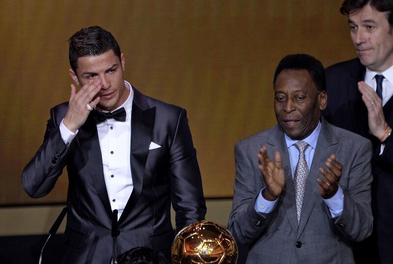 Brazilian legend Pele  applauds next to Cristiano Ronaldo, then of Real Madrid, as the Portuguese star receives the 2013 FIFA Ballon d'Or award in Zurich. Pele congratulated Cristiano Ronaldo for 'breaking his record' of goals scored in official matches. AFP