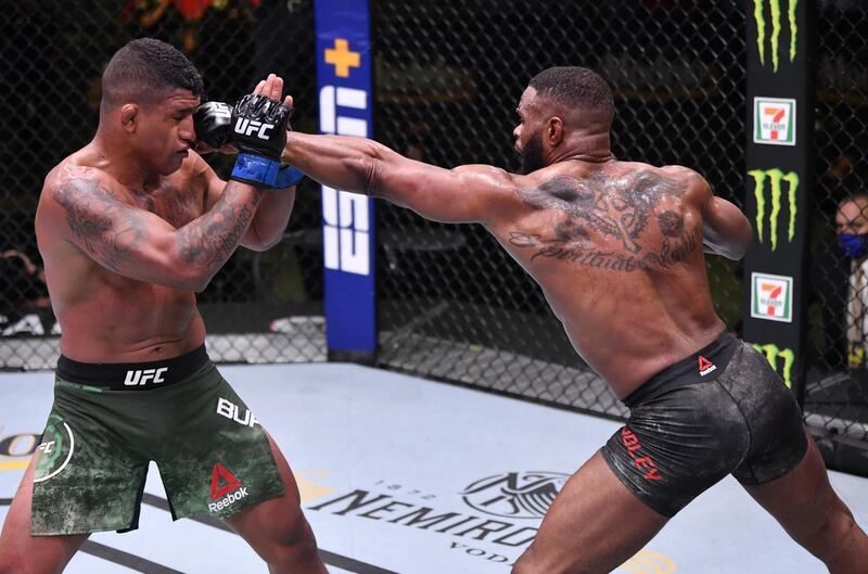 Tyron Woodley (red gloves) punches Gilbert Burns of Brazil (blue gloves) in their welterweight fight during UFC Fight Night in Las Vegas.  Zuffa
