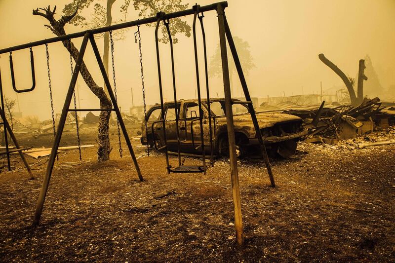 A charred swing set and car are seen after the passage of the Santiam Fire in Gates, Oregon. AFP