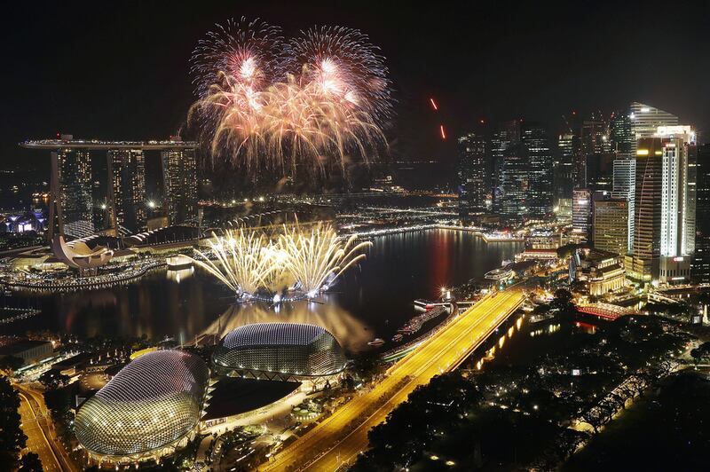 Fireworks explode above Singapore’s financial district at the stroke of midnight to mark the New Year’s celebrations. Wong Maye-E / AP Photo