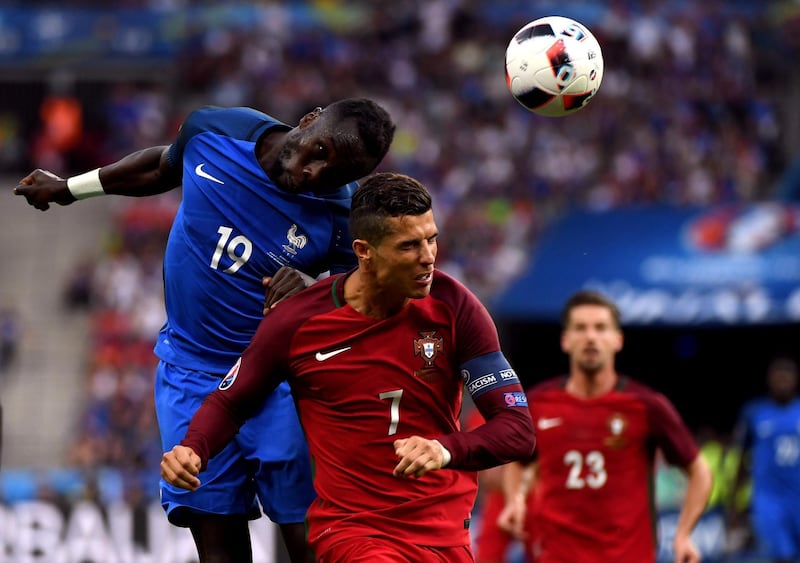 PARIS, FRANCE - JULY 10:  Bacary Sagna of France wins a header above Cristiano Ronaldo of Portugal during the UEFA EURO 2016 Final match between Portugal and France at Stade de France on July 10, 2016 in Paris, France.  (Photo by Mike Hewitt/Getty Images)