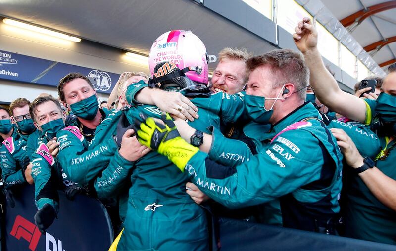 Aston Martin's Sebastian Vettel celebrates with his team after finishing second. Reuters