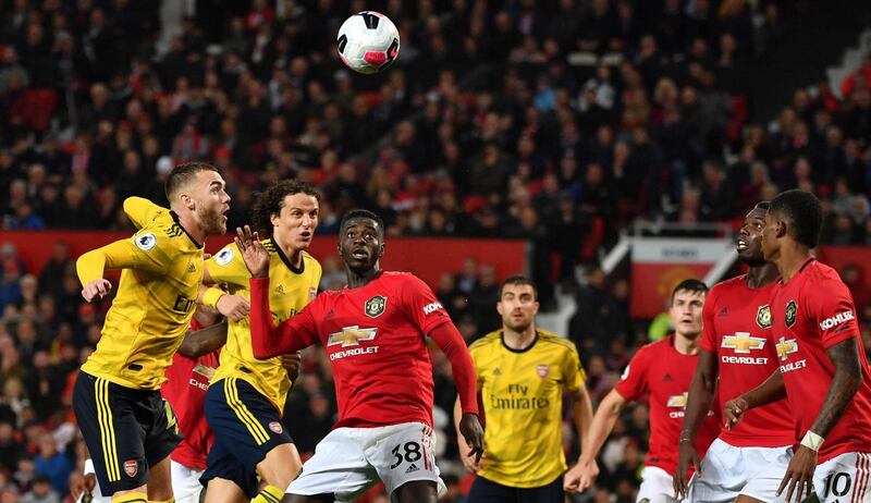 Arsenal's English defender Calum Chambers, left, heads the ball over from a corner in the 1-1 draw against Manchester United at Old Trafford. AFP
