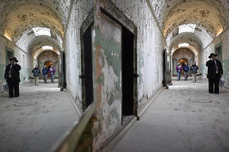 A visitor speaks on the phone in the south corridor of the closed Eastern State Penitentiary in Philadelphia, Pennsylvania. Opened in 1829, with the original corrective system of ‘confinement in solitude with labour,’ the penitentiary housed about 75,000 inmates in its 142 years of operation. Mark Makela / Reuters