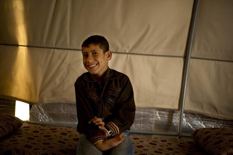 Akram Rasho Khalaf, 10, sits for a photo at the Kaabarto Camp. ‘They were telling us, ‘When you grow up, you will blow yourself up, God willing’.