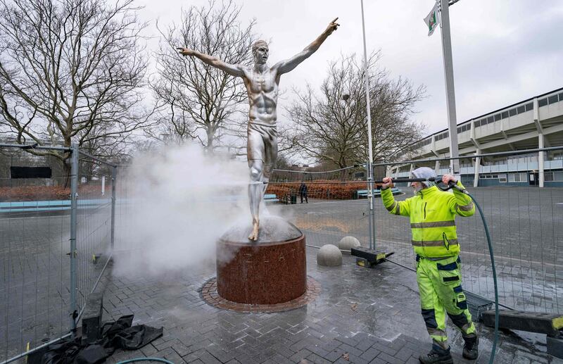 The bronze statue of football player Zlatan Ibrahimovic in Malmo, Sweden, is cleaned on Sunday, December 22, after it was vandalised again following the hometown player's decision to invest in a rival club last month. AFP