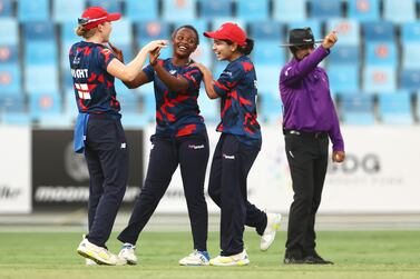 DUBAI, UNITED ARAB EMIRATES - MAY 06: Henriette Ishimwe (C) celebrates the wicket of Chamari Athapaththu of Falcons during the Fairbreak Invitational 2022 T20 match between Barmy Army and Falcons on May 06, 2022 in Dubai, United Arab Emirates. (Photo by Francois Nel / Getty Images)