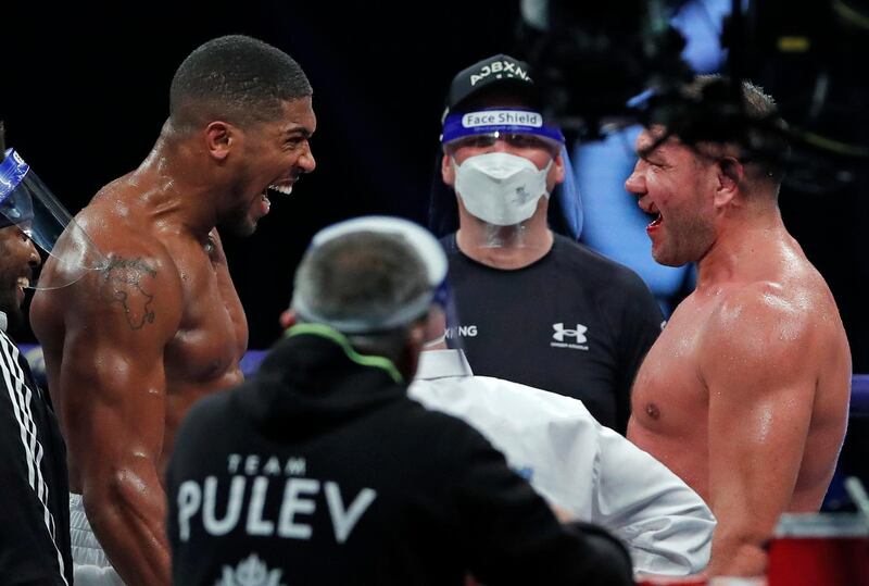 Joshua celebrates after beating challenger Kubrat Pulev at Wembley Arena.