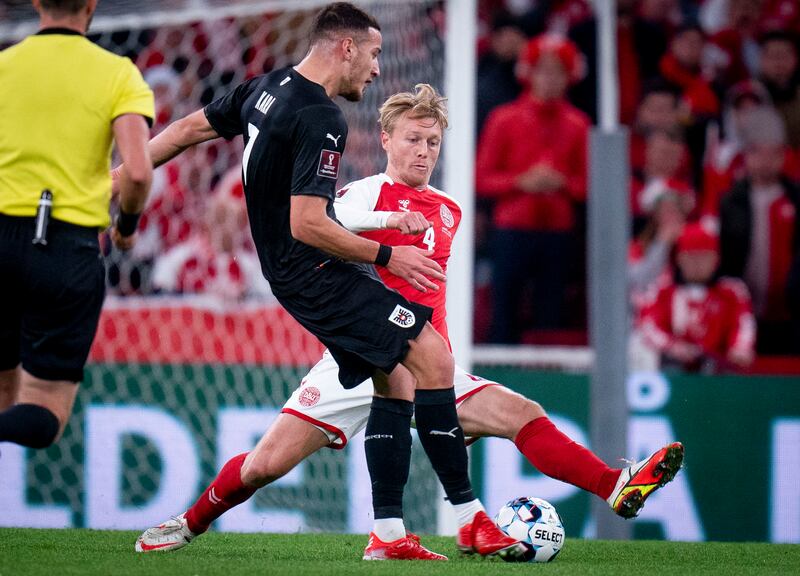 Denmark captain Simon Kjaer challenges Austria's Ercan Kara. AP