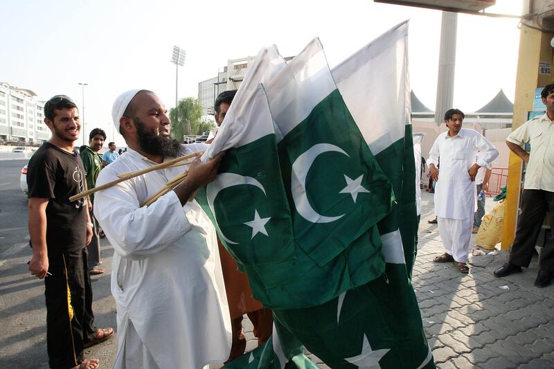 SHARJAH , UNITED ARAB EMIRATES Ð Aug 28 : One of the person selling Pakistani flags outside the stadium before the start of the 1st one day international cricket match between Pakistan vs Australia at Sharjah Cricket Stadium in Sharjah. ( Pawan Singh / The National ) For  Sports. Story Paul and Ahmed