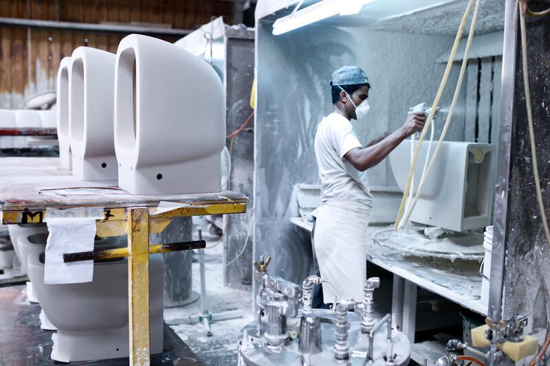 Ras Al Khaimah, June 19, 2013 - A worker sprays a glossy finish on a toilet bowl at the RAK Ceramics factory in Ras Al Khaimah, June 19, 2013. (Photo by: Sarah Dea/The National)


     This set of photos is for a photo page in Business to run over Ramadan 2013. DO NOT USE BEFORE THEN. *** Local Caption ***  SDEA190613-rakceramics38.JPG