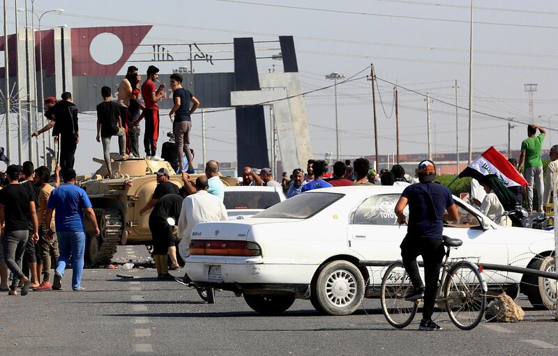 Anti-government protesters block the port of Umm Qasr, south of Basra as Iraqi security forces try to reopen the country's main ports. AP Photo
