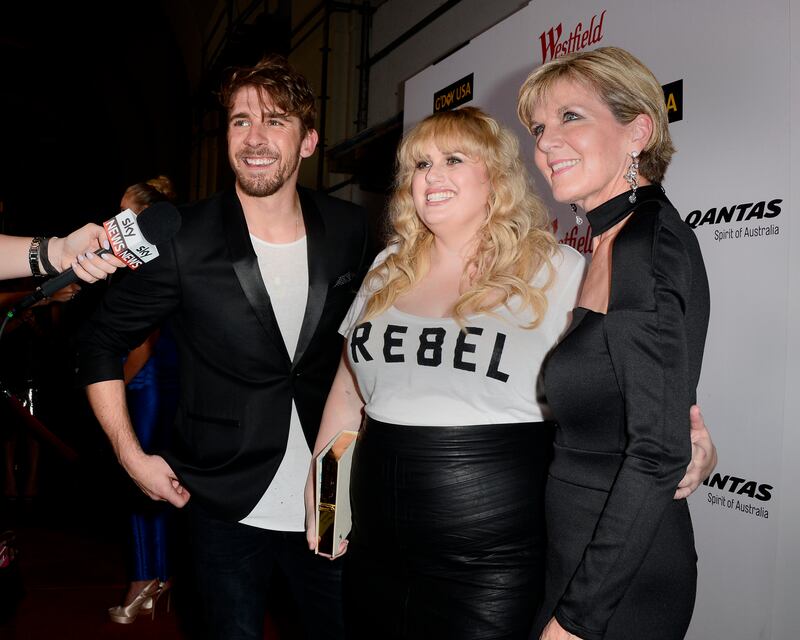 Rebel Wilson, wearing a Rebel for Torrid T-shirt, with politician Julie Bishop and actor Hugh Sheridan, attend Los Angeles Fashion Week at Union Station in Los Angeles on October 8, 2015. EPA