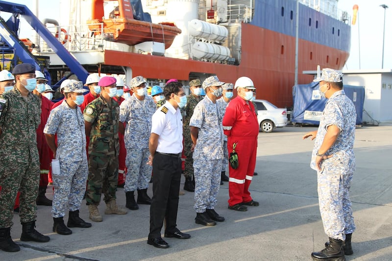 Members of the Royal Malaysian Navy and crew prepare to board a ship to join the search mission of the missing Indonesia's submarine KRI Nanggala. EPA
