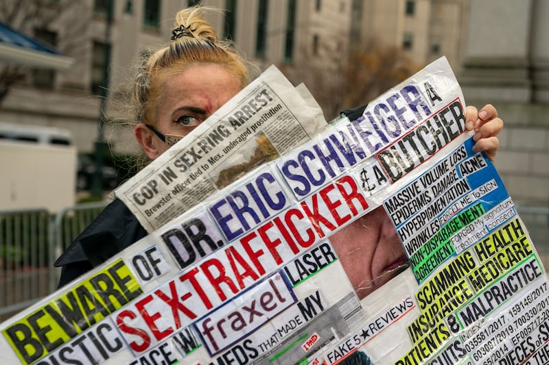 A protester outside Maxwell's trial. Getty / AFP
