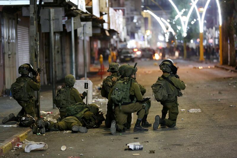 Israeli troops during clashes with Palestinian protesters in Hebron, in the occupied West Bank.  EPA