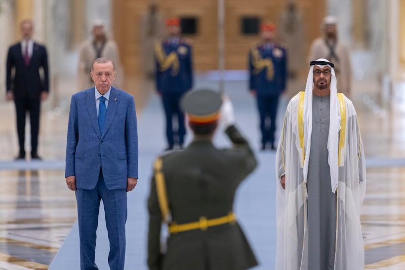 President Sheikh Mohamed and Mr Erdogan stand for the national anthem during the official reception. Photo: UAE Presidential Court