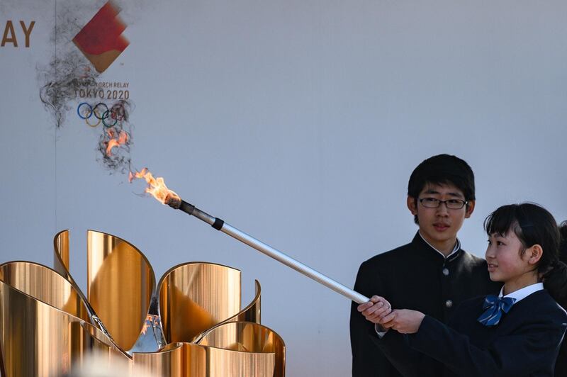 The Olympic flame is displayed at the Aquamarine Fukushima aquarium in Iwaki in Fukushima the day after the historic decision to postpone the 2020 Tokyo Olympic Games. AFP