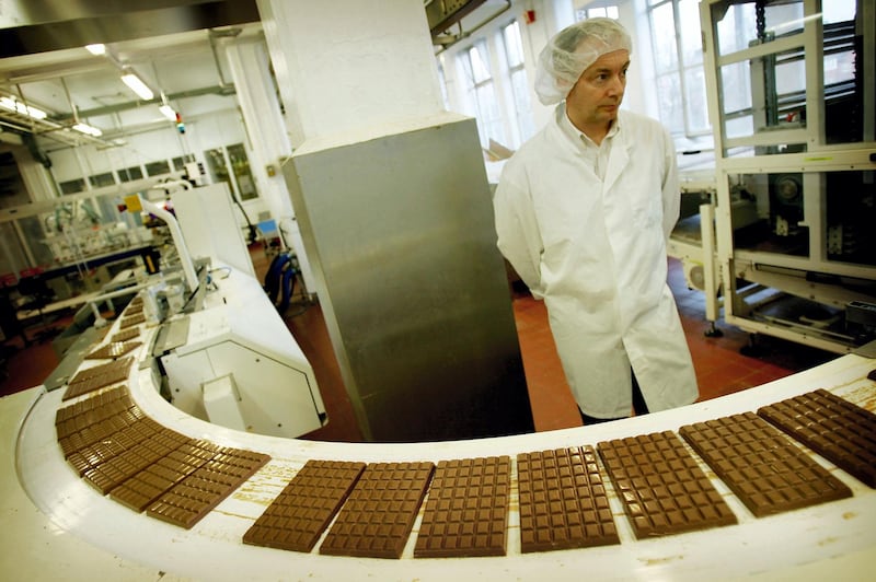 BIRMINGHAM - FEBRUARY 25:  Cadbury's factory worker checks all the chocolate on the production line February 25, 2005 in Birmingham, England. The company is celebrating 100 years of manufacturing at Bournville Cadbury factory. (Photo by Graeme Robertson/Getty Images)