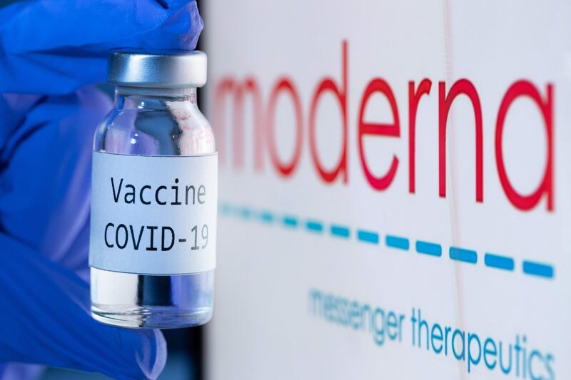 (FILES) This file photo taken on November 18, 2020 shows a bottle reading "Vaccine Covid-19" next to the Moderna biotech company logo. December 18, 2020 FDA issued an emergency use authorization (EUA) for the Moderna vaccine, second vaccine for the prevention of Covid-19 caused by SARS-CoV-2. - -- IMAGE RESTRICTED TO EDITORIAL USE - STRICTLY NO COMMERCIAL USE --
 / AFP / JOEL SAGET / -- IMAGE RESTRICTED TO EDITORIAL USE - STRICTLY NO COMMERCIAL USE --
