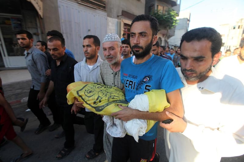 The father of Sahir Abu Namous, 4, carried his body during his funeral after he was killed in an Israeli air strike explosion near his house in the northern Gaza strip. Image by Momen Faiz/Demotix/Corbis