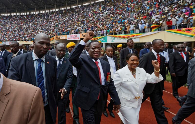 Emmerson Mnangagwa, centre, and his wife Auxillia,  arrive at the presidential inauguration ceremony in Harare, Zimbabwe. Ben Curtis / AP Photo