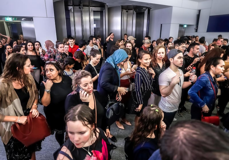 Abu Dhabi, U.A.E., November 12, 2018.  
Cancelled concert of Dua Lipa at the Louvre due to a sudden downpour and gusty winds.  Concert goers take refuge at the Louvre Museum area.
Victor Besa / The National
Section:  NA
Reporter: