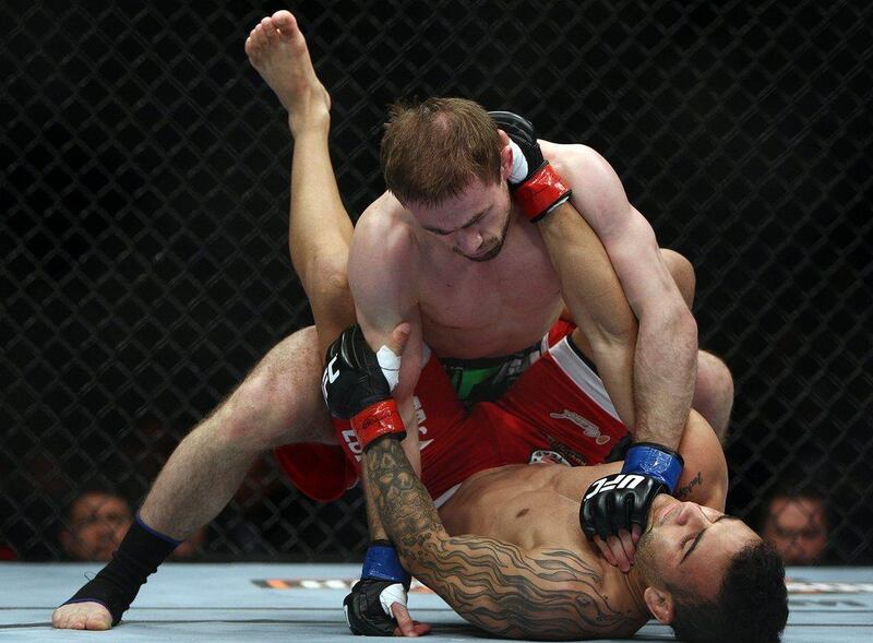 Bagautinov, top, and Lineker, bottom, during their fight on Saturday. Tim Larsen / AP