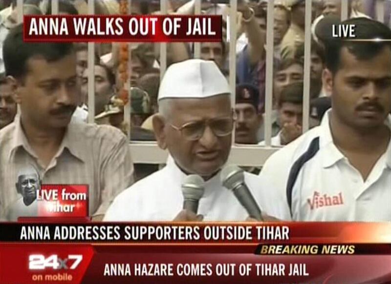 ---- EDITORS NOTE ----- RESTRICTED TO EDITORIAL USE MANDATORY CREDIT "AFP PHOTO / HO / NDTV" NO MARKETING NO ADVERTISING CAMPAIGNS - DISTRIBUTED AS A SERVICE TO CLIENTS NO ARCHIVES

In this frame grab from Indian television channel NDTV on August 19, 2011, Indian social activist Anna Hazare (C) addresses a crowd of supporters after he walked from Tihar Jail in New Delhi.   Indian anti-corruption activist Anna Hazare left jail to start a 15-day hunger strike that poses a fresh threat to the government, following mass nationwide protests against official graft. A huge crowd of frenzied, flag-waving supporters cheered the 74-year-old as he walked out of the gates of Delhi's Tihar jail -- his de-facto campaign headquarters since he was taken into police custody three days ago  AFP PHOTO/HO/NDTV
 *** Local Caption ***  637706-01-08.jpg