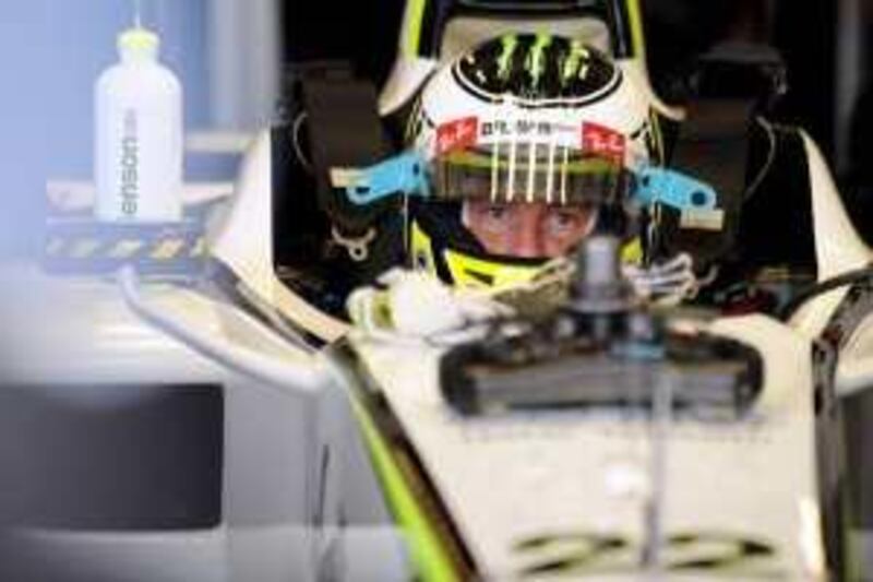 Brawn GP's British driver Jenson Button sits in his car in the pits of the Yas Marina Circuit on October 30, 2009 in Abu Dhabi, during the first free practice session of the Abu Dhabi Formula One Grand Prix.      AFP PHOTO / FRED DUFOUR *** Local Caption ***  139660-01-08.jpg