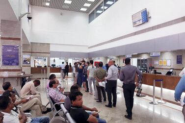 Most service desks were unattended when The National visited Karama post office on Monday afternoon. The National