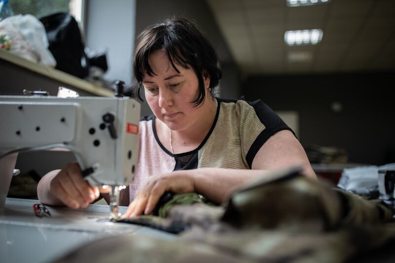 Lubov Baraban sews camouflage fabric for body armour for those fighting for Ukraine against Russia.