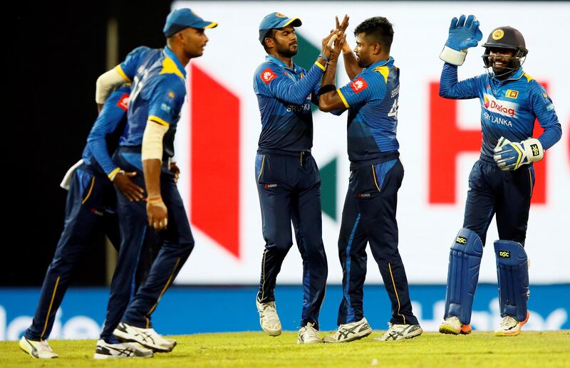 Cricket - Only T20 Match - Sri Lanka v India - Colombo, Sri Lanka - September 6, 2017 - Sri Lanka's  Seekkuge Prasanna celebrates with captain Upul Tharanga and his teammates after taking the wicket of India's Lokesh Rahul (not pictured). REUTERS/Dinuka Liyanawatte