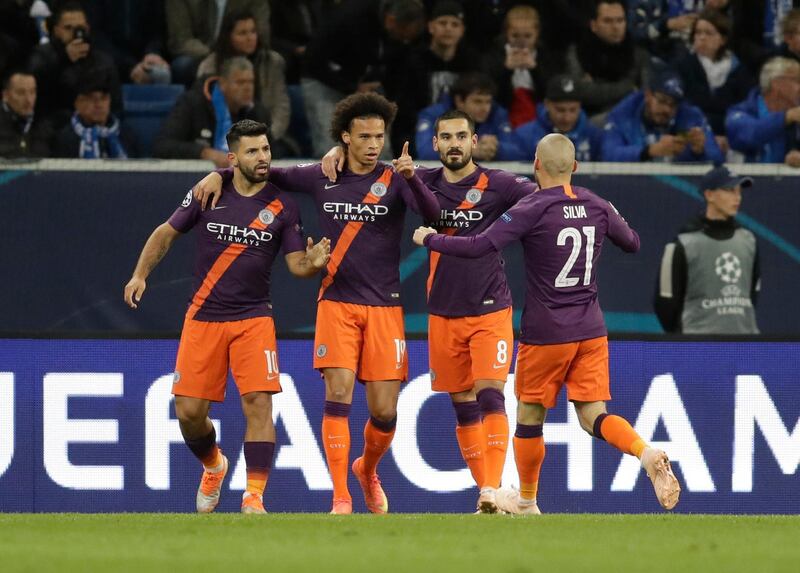 Manchester City's Sergio Aguero, left, celebrates with teammates after scoring his side's opening goal. AP Photo