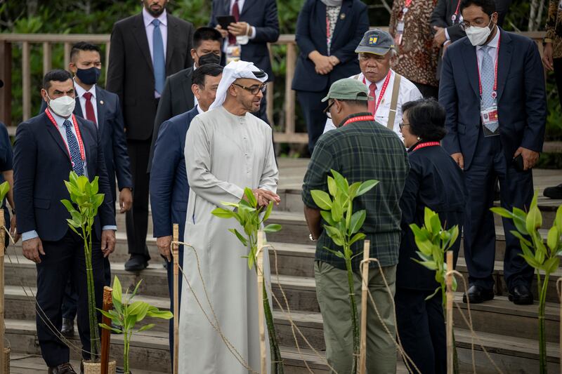 President Sheikh Mohamed speaks with Siti Nurbaya, Indonesia's Minister of Environment and Forestry, after planting a mangrove tree as part of the G20 Summit at the Tahura Ngurah Rai mangrove conservation park. Photo: UAE Presidential Court