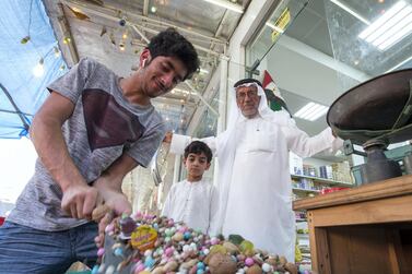 Abdulla Ali Mohsin is the owner of the Islamic Trading Est., one of the stores selling sweets and nuts for Hag Al Leila, and he stands with his grandsons in Ras Al Khaimah. Leslie Pableo / The National 