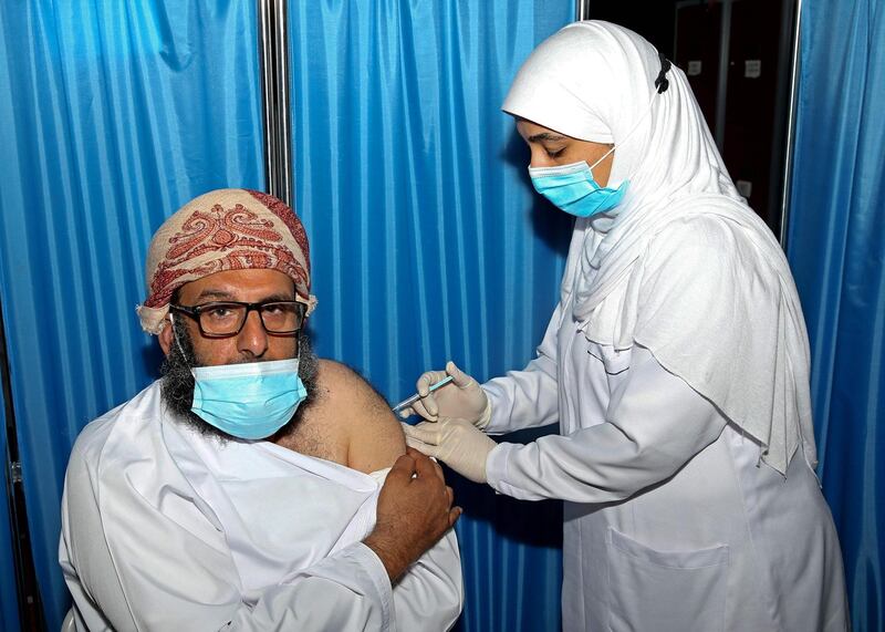 An Omani man receives a dose of the Pfizer/BioNTech Covid-19 vaccine at the Sultan Qaboos Sports Complex in Oman's capital Muscat. AFP